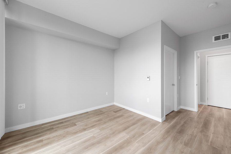14_bedroom Bedroom with wood-look flooring, neutral walls, and spacious layout.