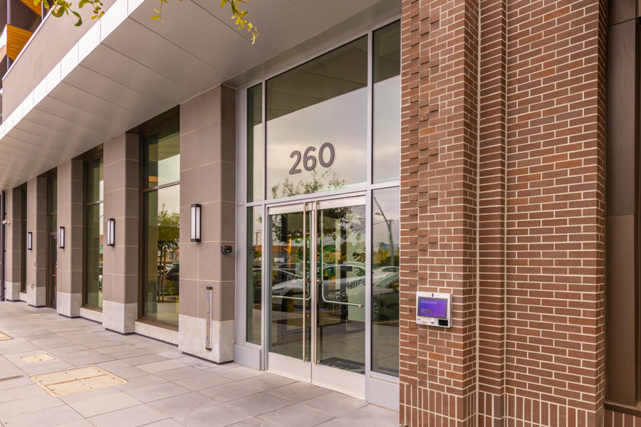 52_facade Residential building entrance with glass doors and street-facing facade.