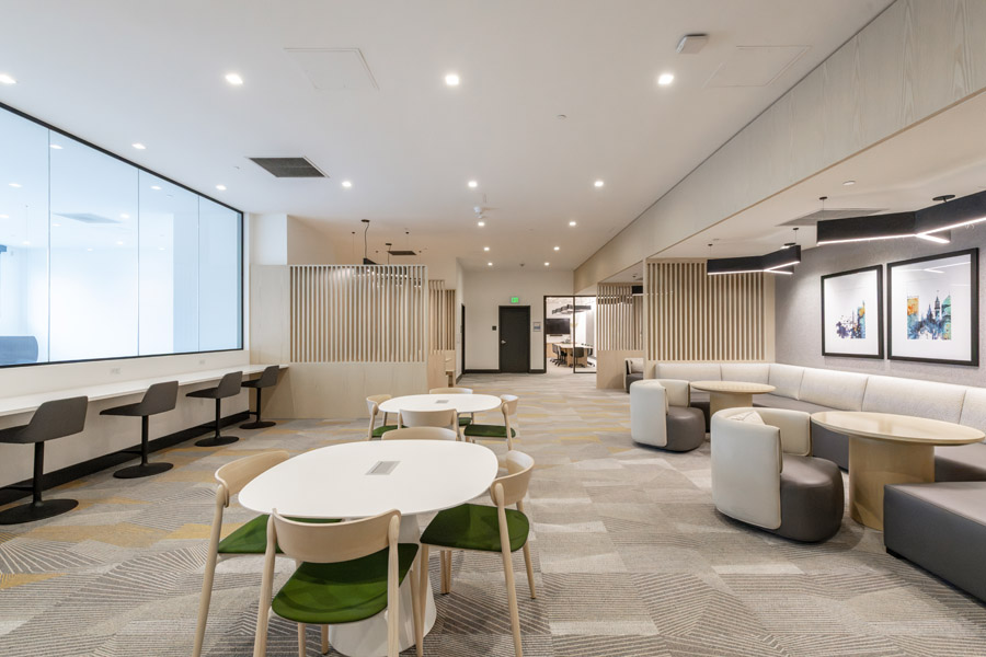 56_work_lounge Resident coworking lounge with communal tables, seating areas, and workspace amenities.