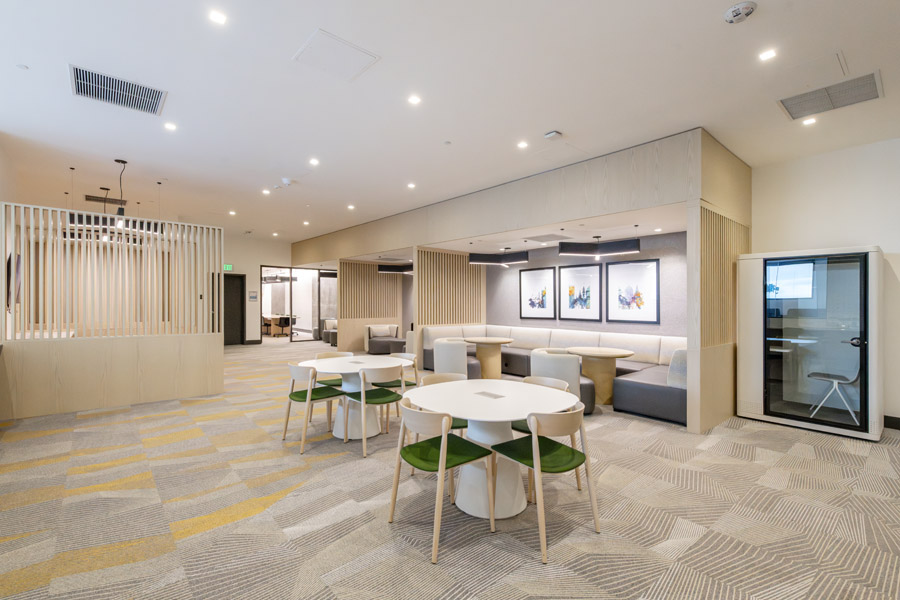 57_work_lounge Coworking lounge with collaborative tables, private seating, and modern workspace design.