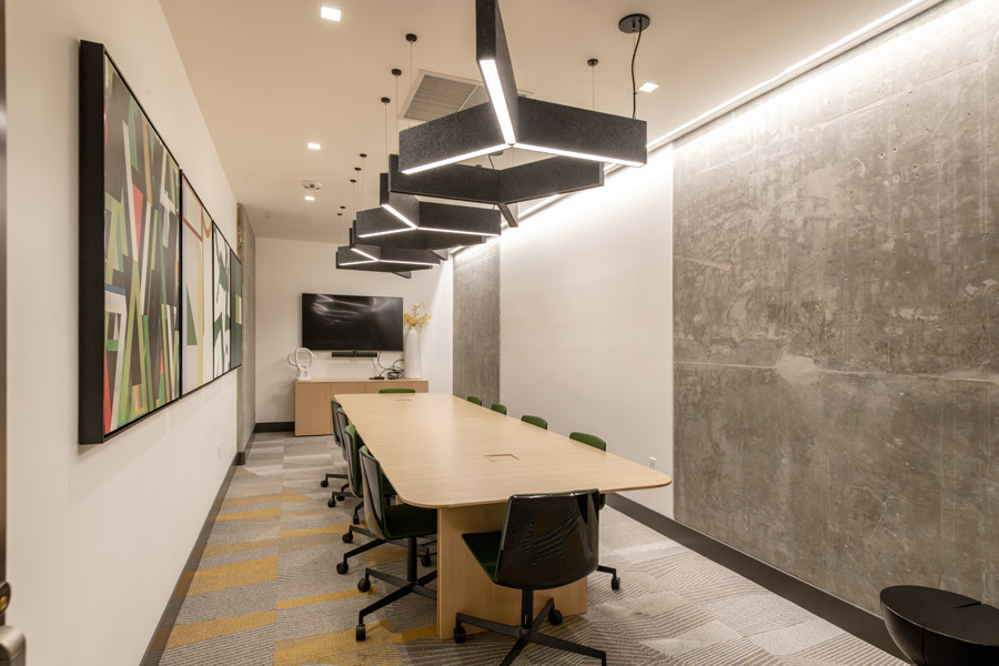 60_work_lounge Private conference room with meeting table, chairs, and wall-mounted television.