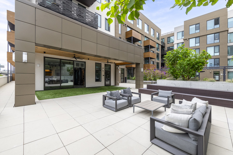 63_courtyard Shared courtyard with outdoor lounge seating and landscaped gathering areas.