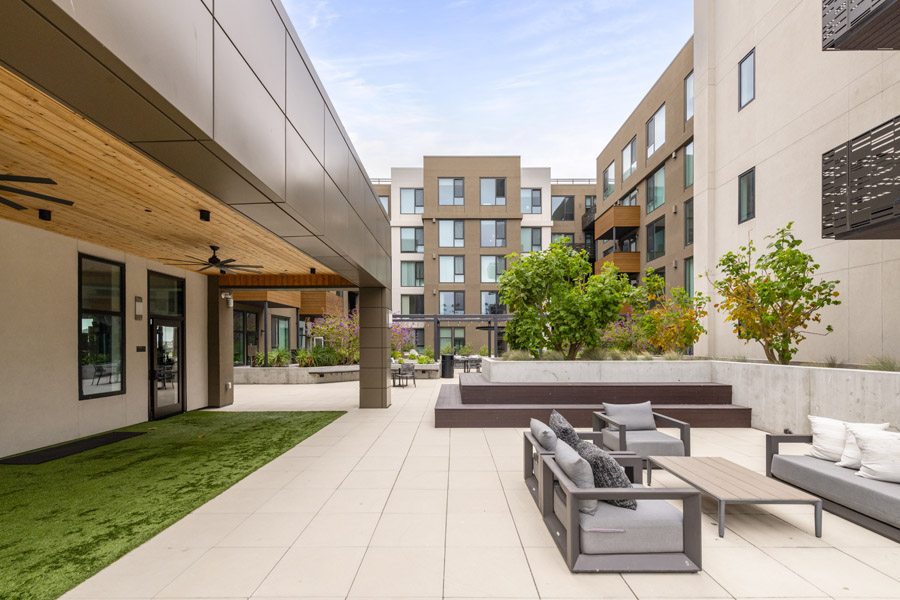 64_courtyard Residential courtyard with outdoor seating, landscaped planters, and open walkways.