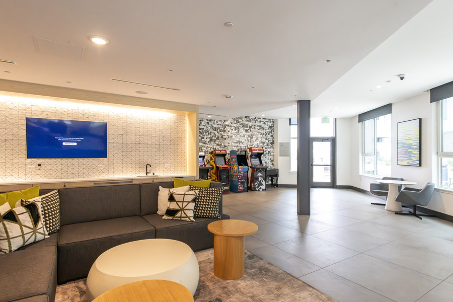 69_lounge Resident lounge with seating areas, television, and modern common space.