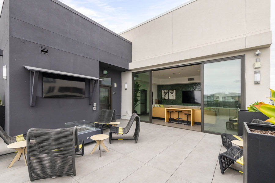 71_roof_terrace Rooftop terrace with outdoor seating, television, and lounge area.