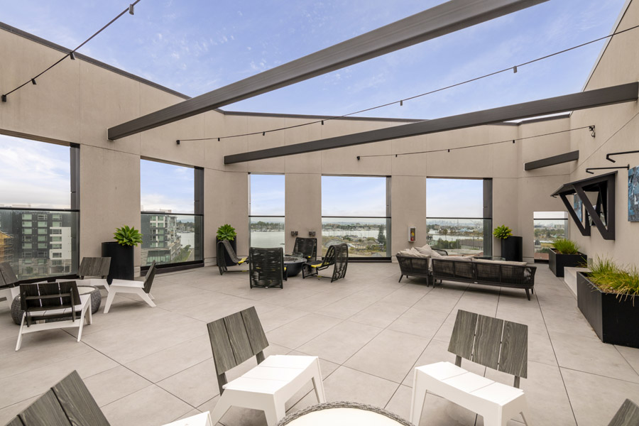 74_roof_terrace Shared rooftop terrace with lounge seating, dining tables, and waterfront views.