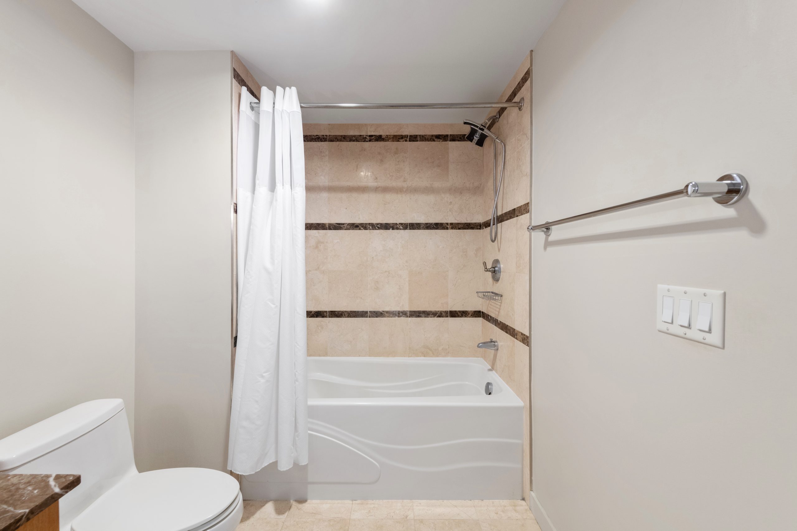Bathroom with vanity sink, toilet, and tub-shower combination.