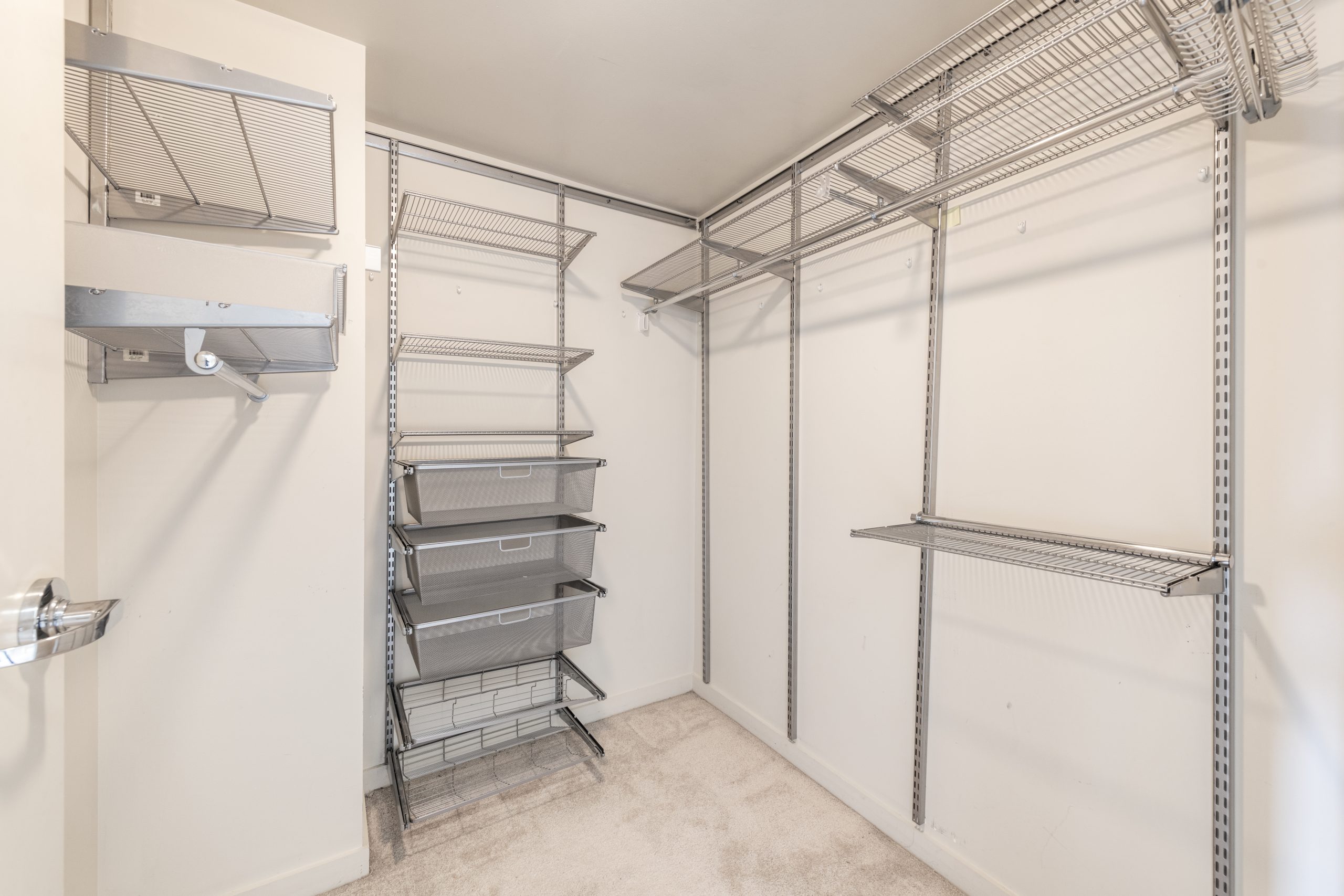 Walk-in closet with built-in shelving, hanging storage, and drawer organizers.