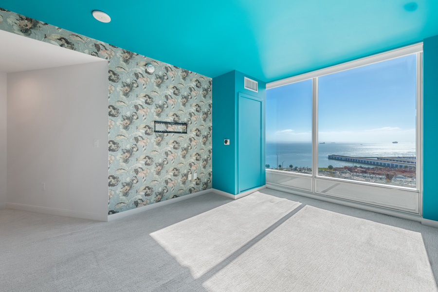 19_primary Primary bedroom with large window, carpeted flooring, and waterfront views.