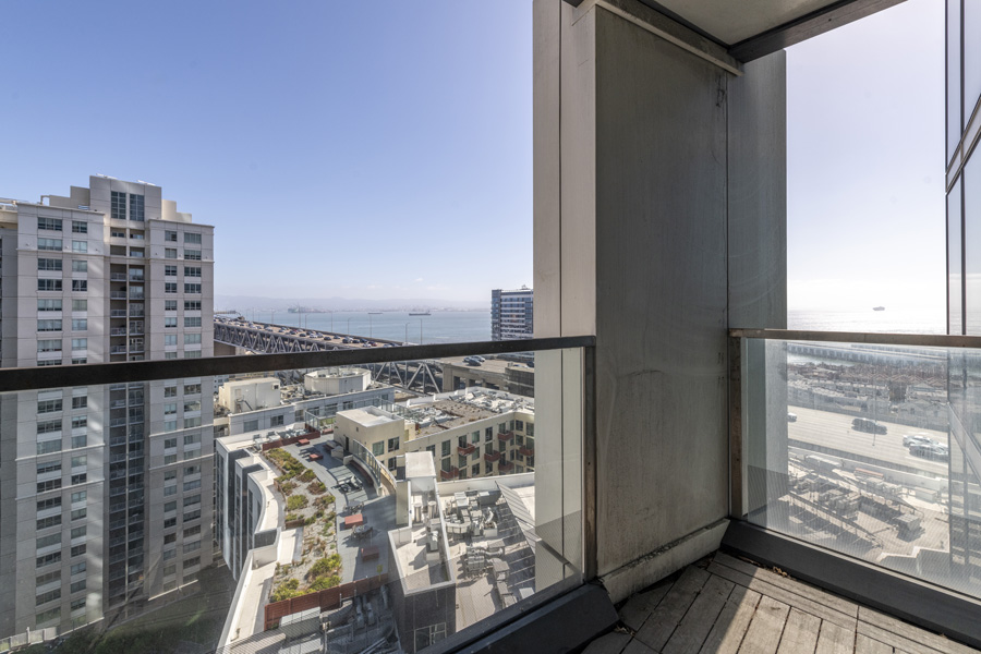 25_balcony Private balcony with glass railing overlooking the Bay Bridge and waterfront.