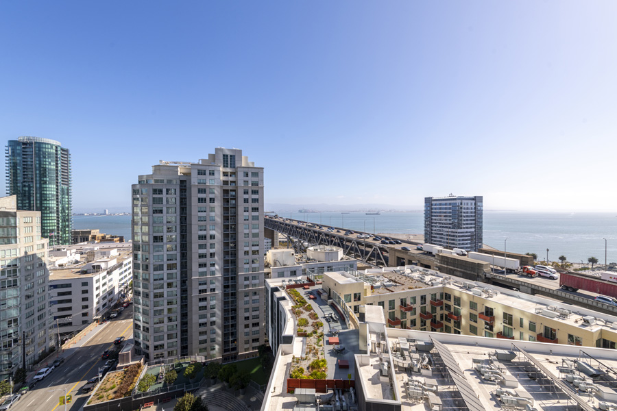 26_view Waterfront view overlooking the bay, pier, and surrounding residential buildings.
